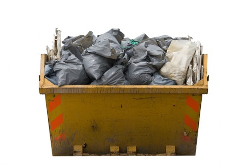 Construction workers managing waste materials on a construction site in Hainault