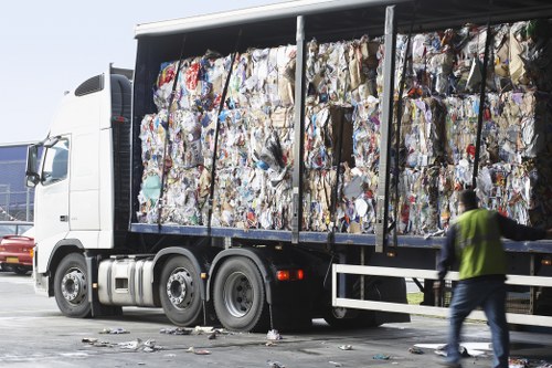 Workers separating materials in a recycling depot